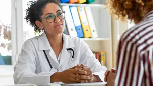 Female patient speaking with her paediatrician in a doctors office