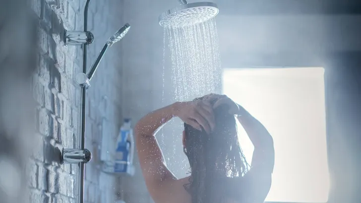 Asian woman Taking a shower with a rain shower The back of her p