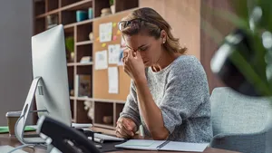 Business woman having headache at office