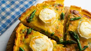 French style quiche with green asparagus, eggs, and slices of goat cheese.