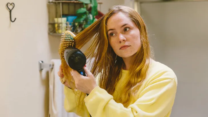 Young Adult Blow Drying and Brushing Hair