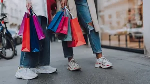 Young women with shopping bags standing on the street