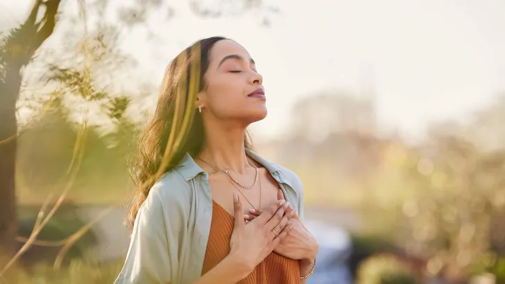 Mixed race woman relax and breathing fresh air outdoor at sunset