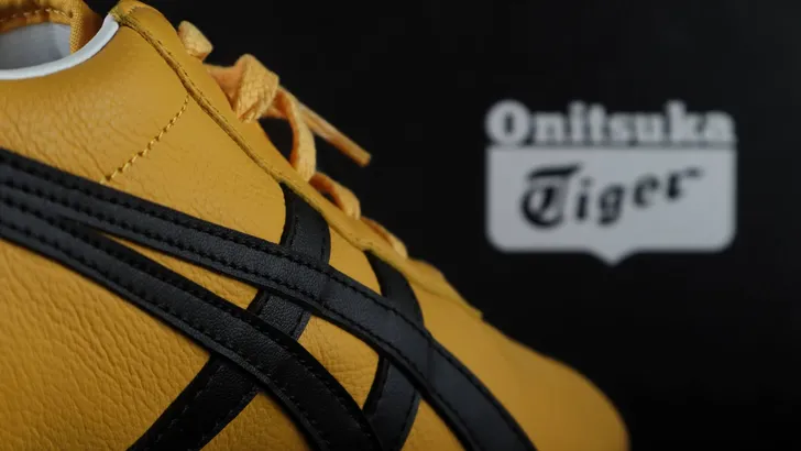 Tokyo, Japan, 23 March 2021,The yellow black Tai Chi Reb Onitsuka Tiger sneaker sport footwear is displayed on the black display shelf in the Onitsuka Tiger shop in Shinjuku branch during summer sales