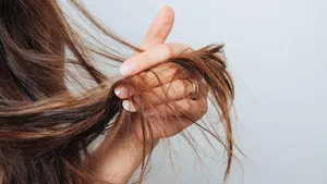 Girl holding her hair in her hand. Hair care concept. Shampoo. Haircut needed.