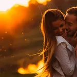 passionate hug of a couple in love on the shore of an evening la