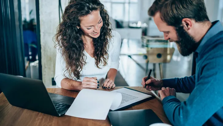 Business people signing a contract.