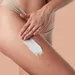 Vrouw is haar billen aan het insmeren met crème.
