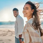 Shot of a young couple spending time together at the beach