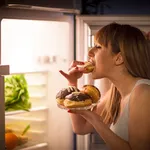 Young woman having a midnight snack