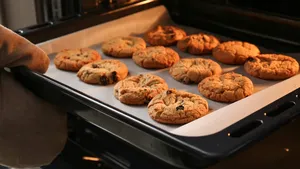 Baking tray with tasty homemade cookies taking out from oven