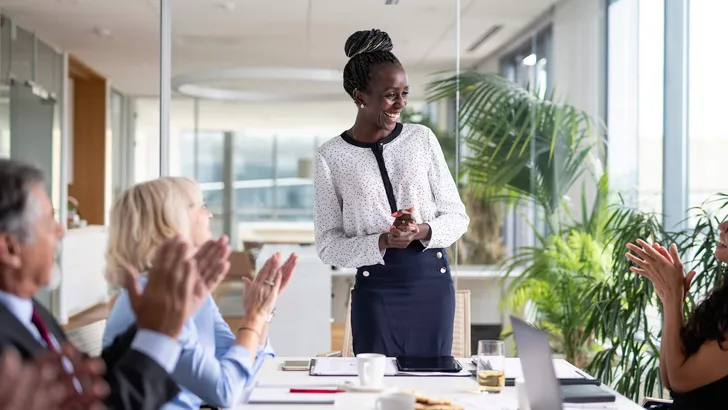 Diverse Group of Executives Applauding African Female CEO