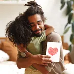 Young happy african american family celebrating Fathers day at home