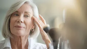 Attractive senior woman looking in the mirror