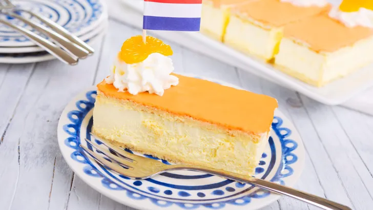 Orange tompouce, traditional Dutch pastry, on a rustic table