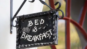 Cute metal Bed and Breakfast sign on building facade