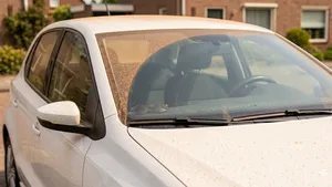 Witte auto met oranje laag saharazand.