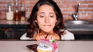 Woman on the diet craving to eat cake