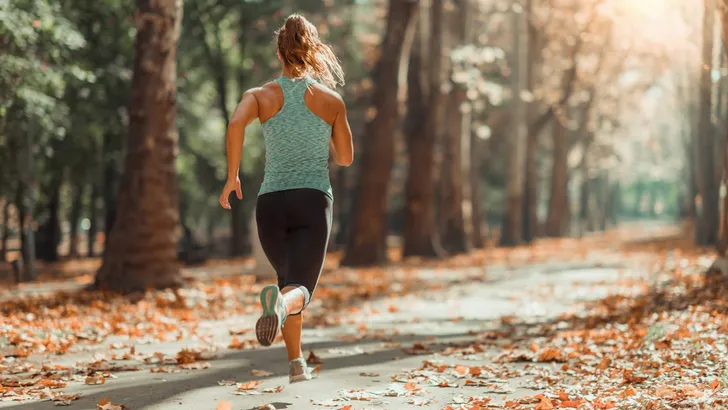 Woman Jogging Outdoors in The Fall
