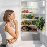 Woman with healthy vegetables in the fridge