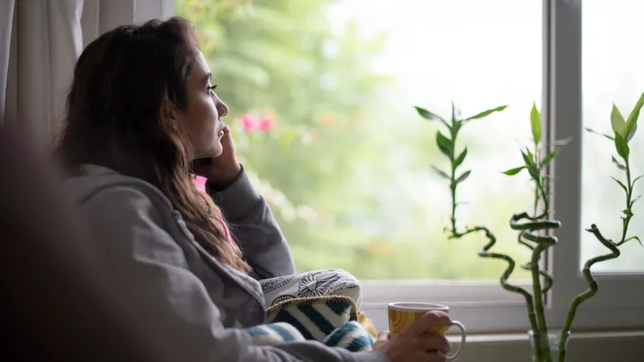 Depressed Woman Sitting by Window