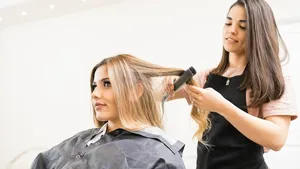 Hairstylist ironing some hair