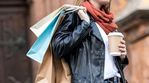 woman with shopping bags and coffee to go