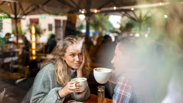 Young couple enjoying their coffee in a bar