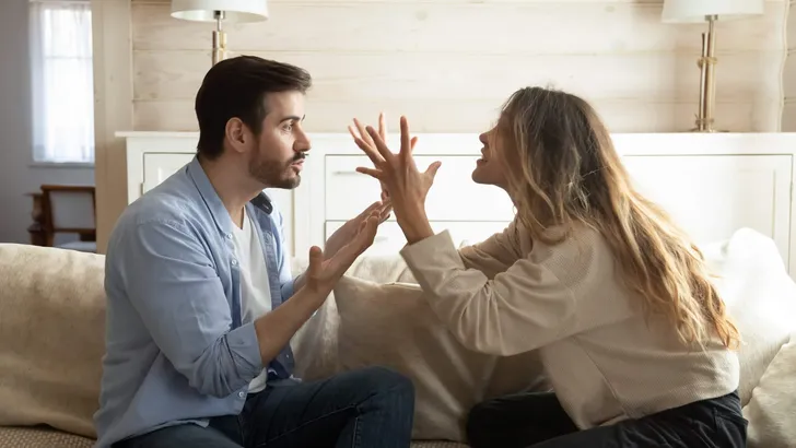 Emotional annoyed stressed couple arguing at home.