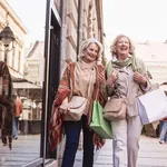 Social Seniors. Senior women shopping, having fun and laughing on the street