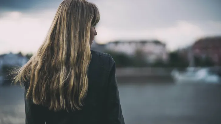 Portrait of lonely and pensive woman who is looking at distance.