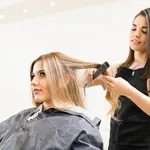 Hairstylist ironing some hair