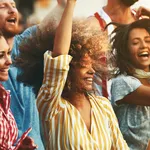 Group of friends dancing at a concert.