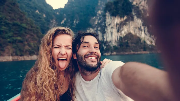 Couple taking selfie on a longtail boat