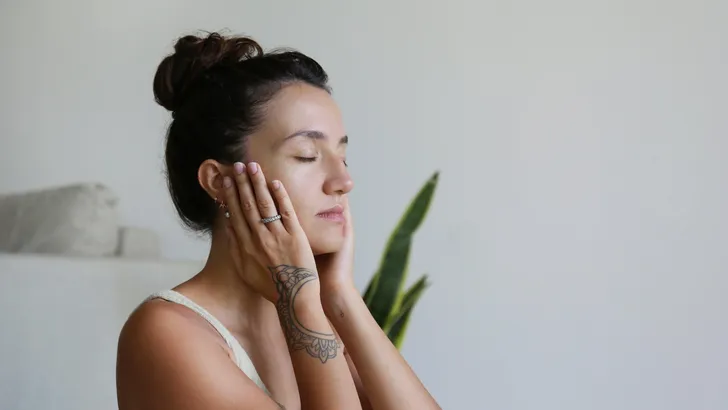 Young middle eastern woman doing the aroma therapy procedures with the natural essential oils on her skin. Close up, copy space, background.