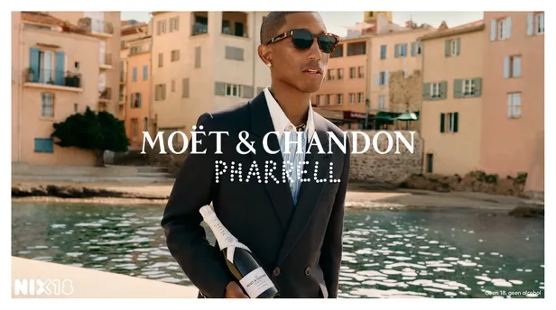 Pharrell Williams met een fles Moët & Chandon onder zijn arm. 