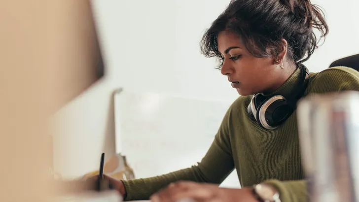Female computer programmer working at her desk