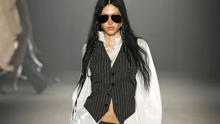 Een model met een streepjes gilet en broek aan