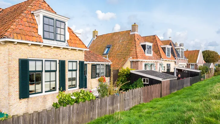 Back of old cottages alongside dike in historic town of Makkum, Friesland, Netherlands