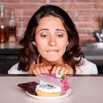 Woman on the diet craving to eat cake