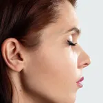 Beautiful, young girl Detail of the head with the female human ear and hair close-up, portrait in profile.