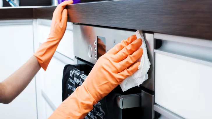 Woman Cleaning Oven