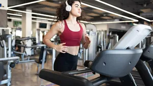 Pretty latin young woman going on a run at the gym