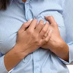 Woman clutching her breast in pain