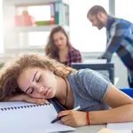 Stressed Woman Sleeping In Office