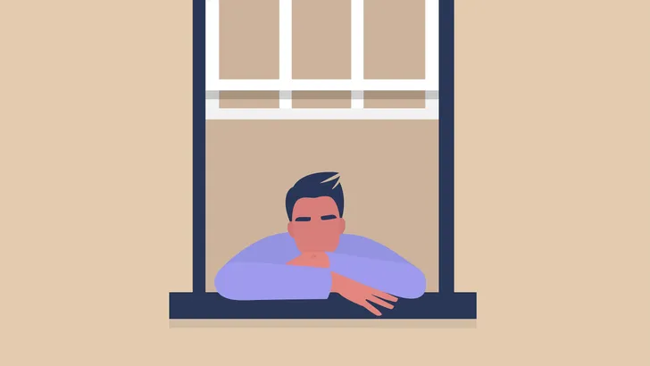 Iemand die uit het raam staart.