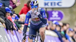 Tim van Dijke komt met de hand voor de mond over de finish in Omloop Het Nieuwsblad.