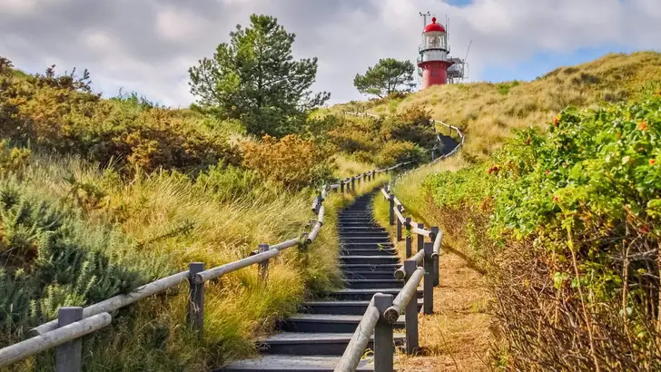 Stairs towards the lighthouse of the Frisian Island of Vlieland. The Frisian Islands, also known as the Wadden Islands or Wadden Sea Islands, form an archipelago at the eastern edge of the North Sea