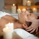 Young beautiful girl having face massage relaxing in spa salon.