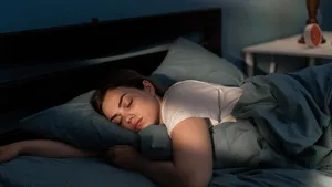 Young female sleeping peacefully in her bedroom at night. Relaxing at nighttime